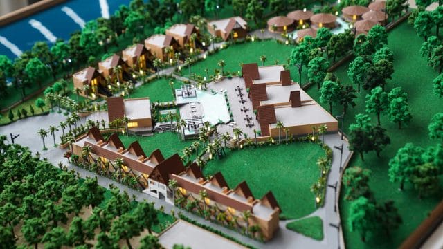Architectural model of 60 Ananta Gir resort with lush greenery and modern amenities.