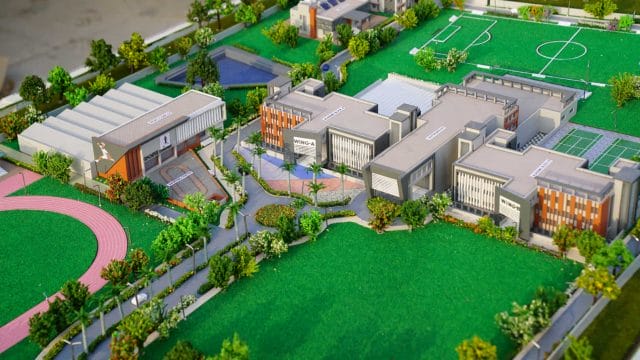 A modern school campus with sports fields, classrooms, and green spaces at 62 Shalom International S.