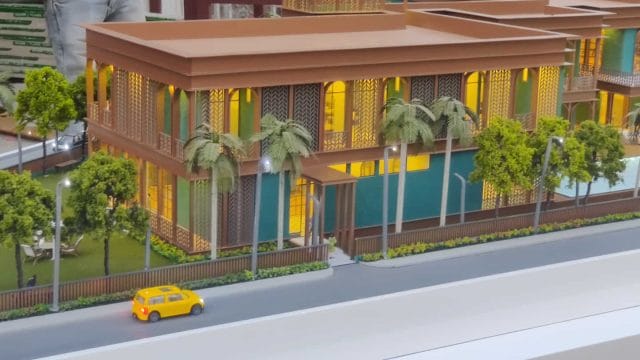 Beige Newt model building with tropical trees and colorful accents, inspired by 68 Mangalam Rambhag.