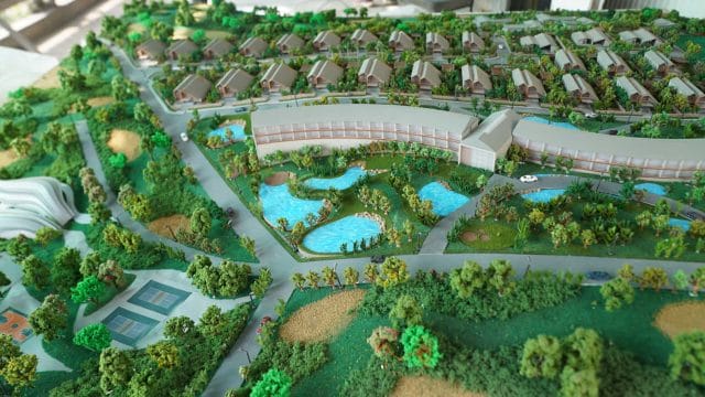 Detailed model of 70 Mount Kusur by Clarks with lush greenery and water features.