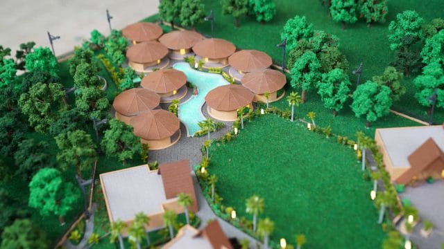 Model of a tropical resort with pools, umbrellas, and lush greenery, inspired by 60 Ananta Gir.
