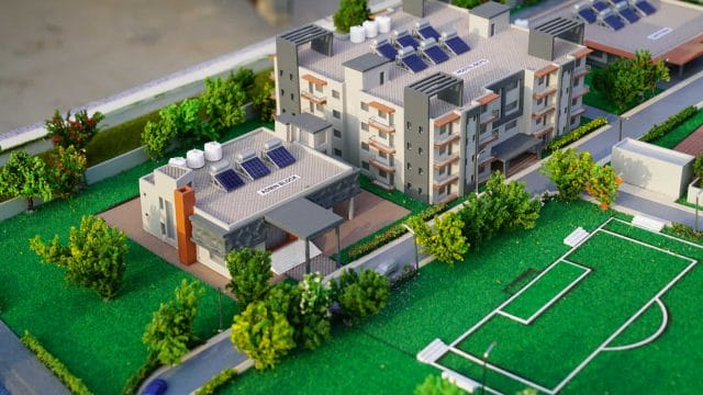 Modern school building with solar panels and sports field at 62 Shalom International School.