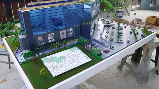 Beige Newt model display at 64 GT South City exhibition, showcasing modern urban development and arc.