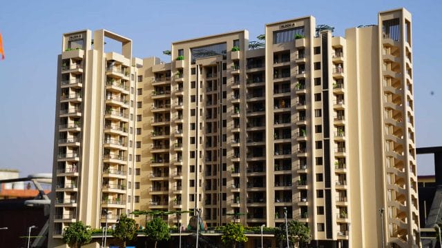 Beige modern residential building with multiple balconies and greenery, part of 66 Alaya by GBD Grou.