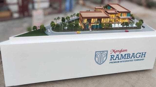 Beige Newt model of Mangalam Rambhag Club residential project with landscaped gardens.
