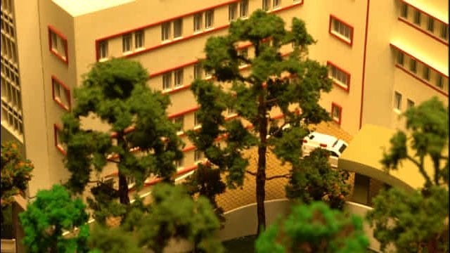 Beige hospital building with surrounding greenery at 63 St. George's Hospital, Mumbai.