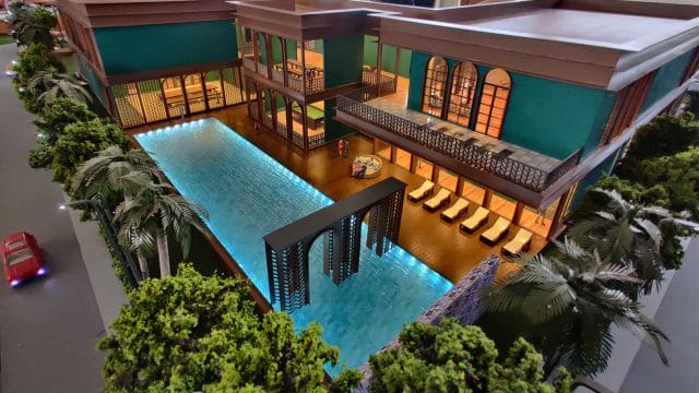 Modern hotel pool area with tropical landscaping and stylish architecture.