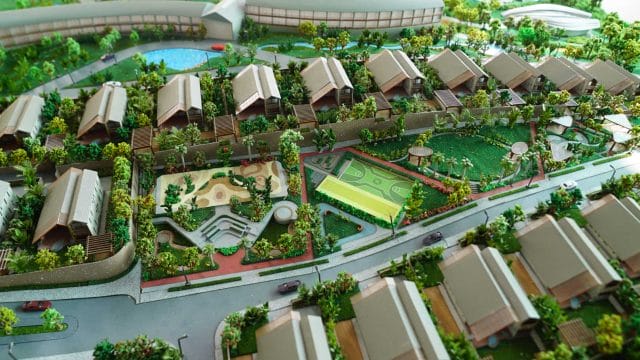 Modern residential community with sports facilities and lush greenery near Mount Kusur.