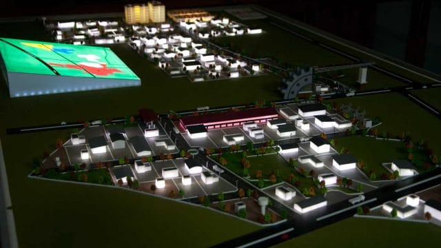 Beige newt model of 72 Solitaire Park by Kgk Realty, showcasing a detailed layout of residential and.