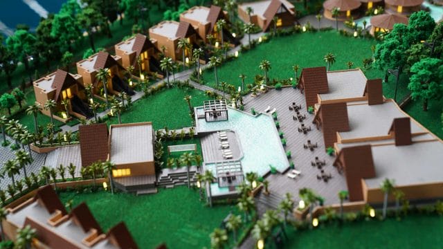 Beige Newt model of resort with villas and lush greenery, inspired by 60 Ananta Gir.
