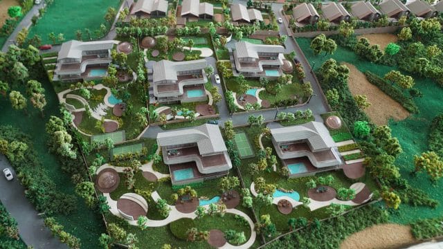 Beige Newt 372921: Modern residential complex with lush landscaping and swimming pools.