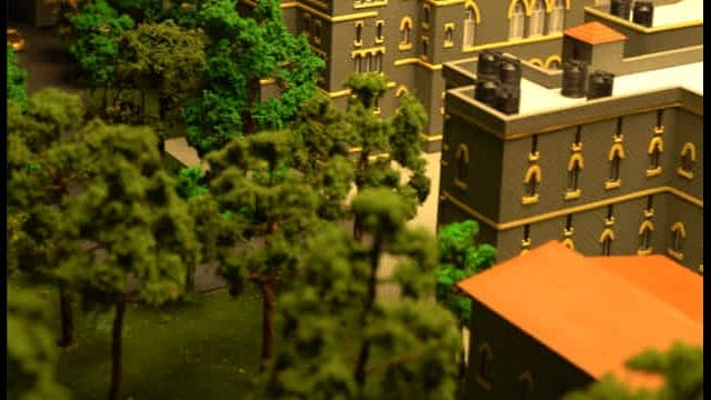 Elegant model of a historic building with lush greenery, representing architectural heritage near 63.