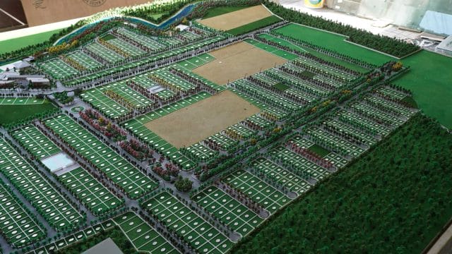 A detailed scale model of the 69 Brookside by Lok8 Infra, Nagpur, showcasing residential plots and g.
