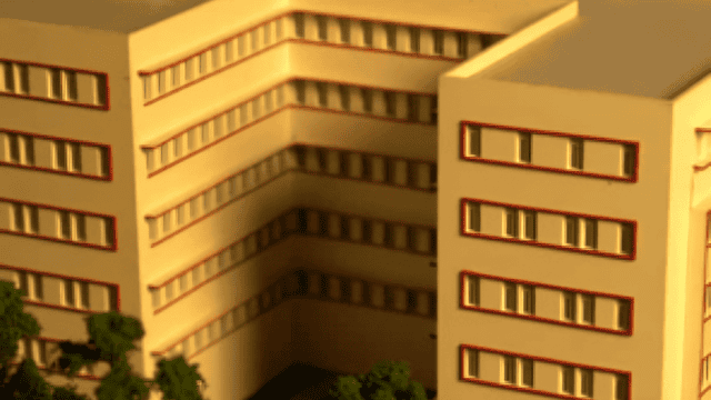 Beige modern hospital building at 63 St. George's Hospital, Mumbai, with multiple windows and surrou.