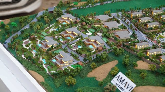 Beige Newt model of Mount Kusur residential development with lush greenery and modern villas.