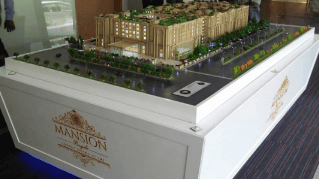 Beige mansion model for 49 Mansion Royale by JMJ Group display.